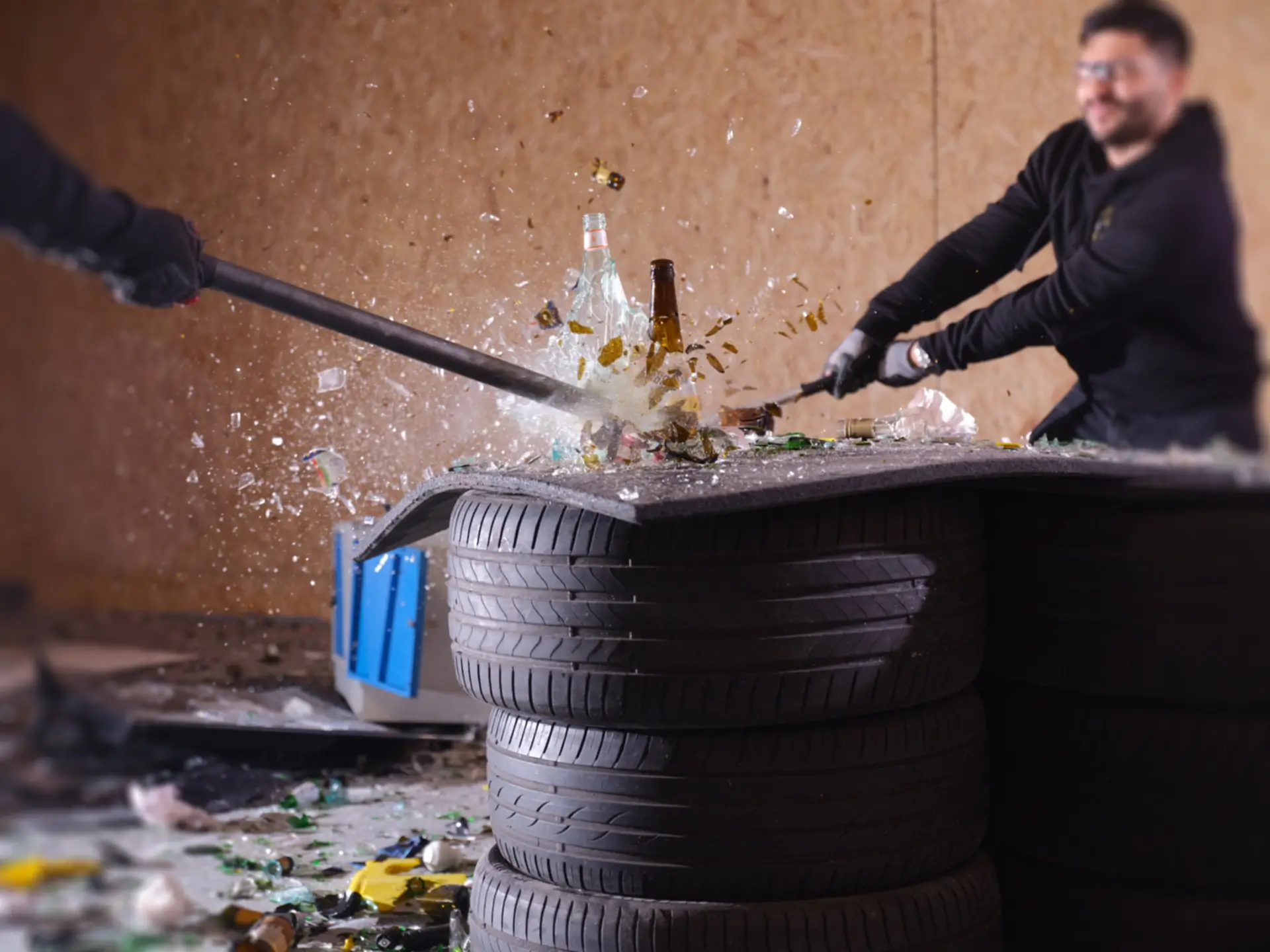 Man smashing bottles in rage room during intense smashing session